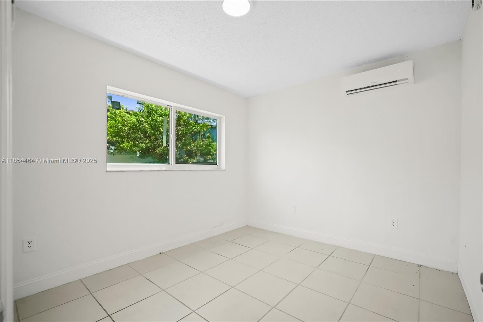 2622 Northwest 24th Street, Unit 2 Miami, FL 33142 - Photo 13 of 20 an empty room with a window