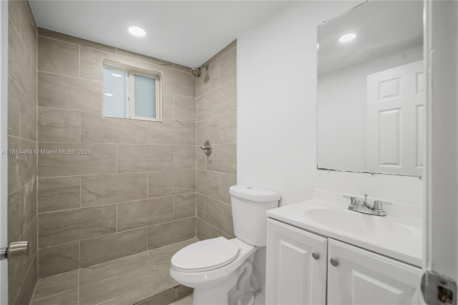 2622 Northwest 24th Street, Unit 2 Miami, FL 33142 - Photo 14 of 20 a bathroom with a sink a toilet and shower