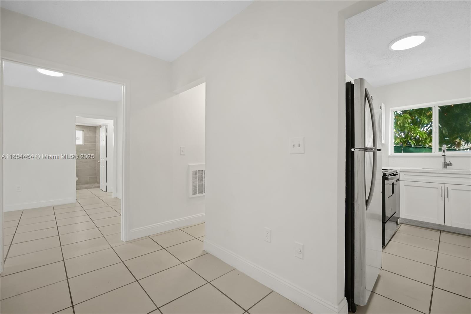 2622 Northwest 24th Street, Unit 2 Miami, FL 33142 - Photo 4 of 20 a view of kitchen with furniture and window