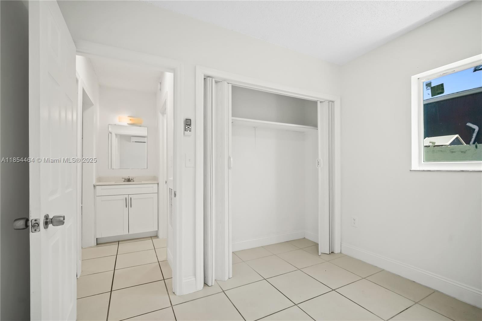 2622 Northwest 24th Street, Unit 2 Miami, FL 33142 - Photo 9 of 20 an empty room with closet and mirror