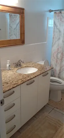 a kitchen with stainless steel appliances granite countertop a sink and a refrigerator