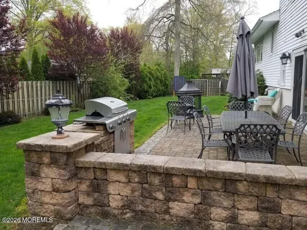 a view of a patio with table and chairs potted plants with wooden fence