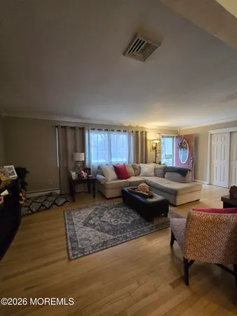 a living room with furniture wooden floor and window