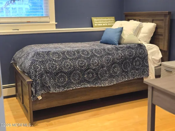 a bed sitting in a bedroom next to a window