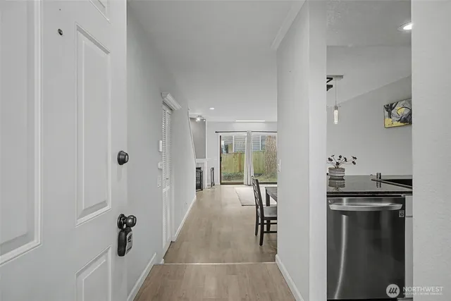 a hallway with sink and wooden cabinets