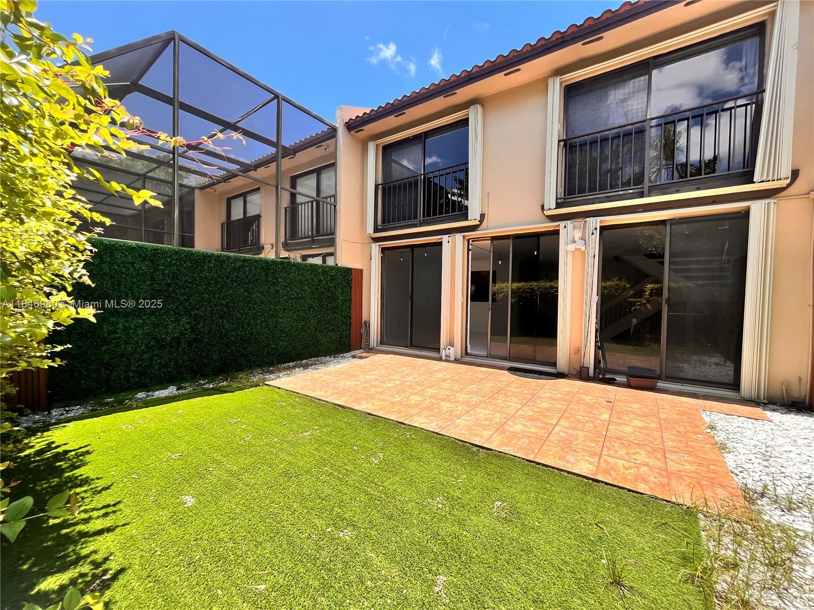 9809 Costa Del Sol Boulevard, Unit E102 Doral, FL 33178 - Photo 5 of 7 a house view with a garden space