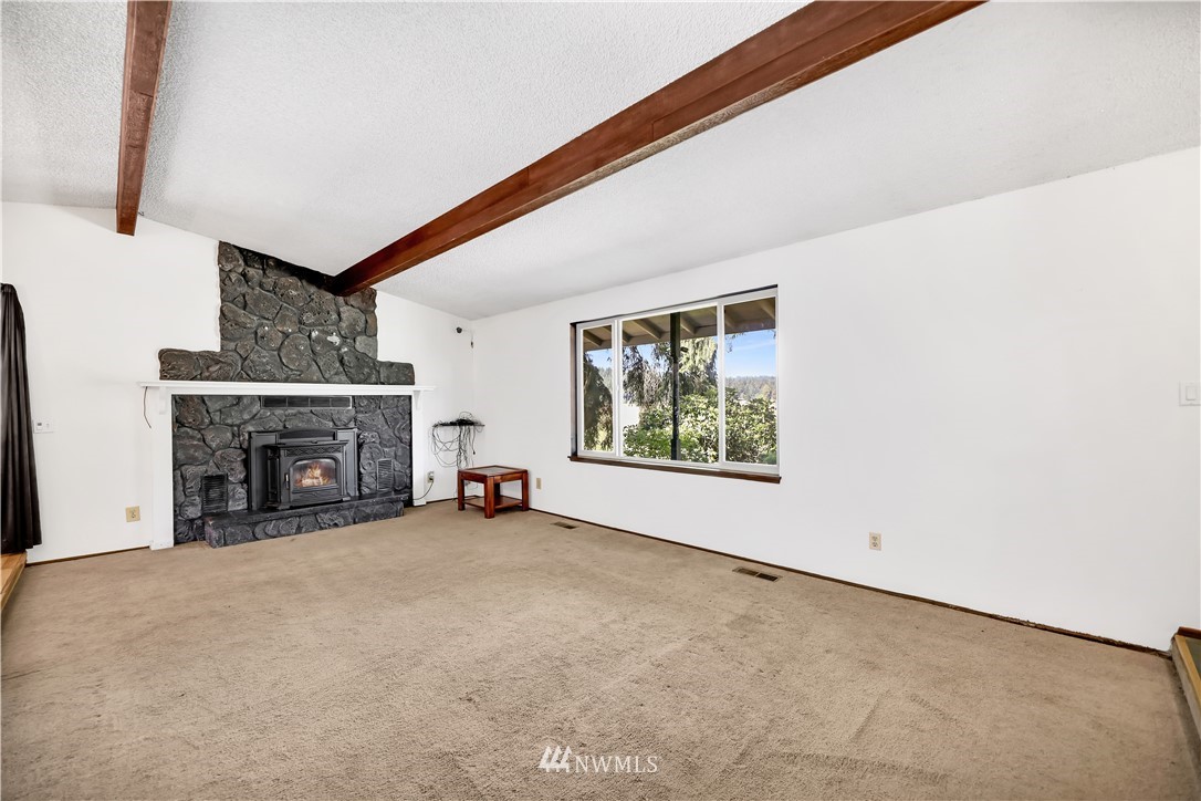 2501 Connors Road Snohomish, WA 98290 - Photo 23 of 40 a view of an empty room with a fireplace and a window