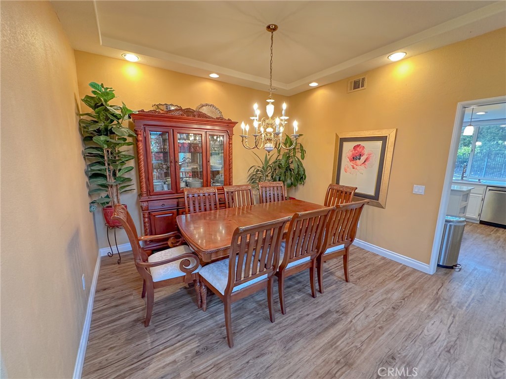 31785 Vía Del Viento Trabuco Canyon, CA 92679 - Photo 11 of 50 a dining room with furniture a chandelier and wooden floor