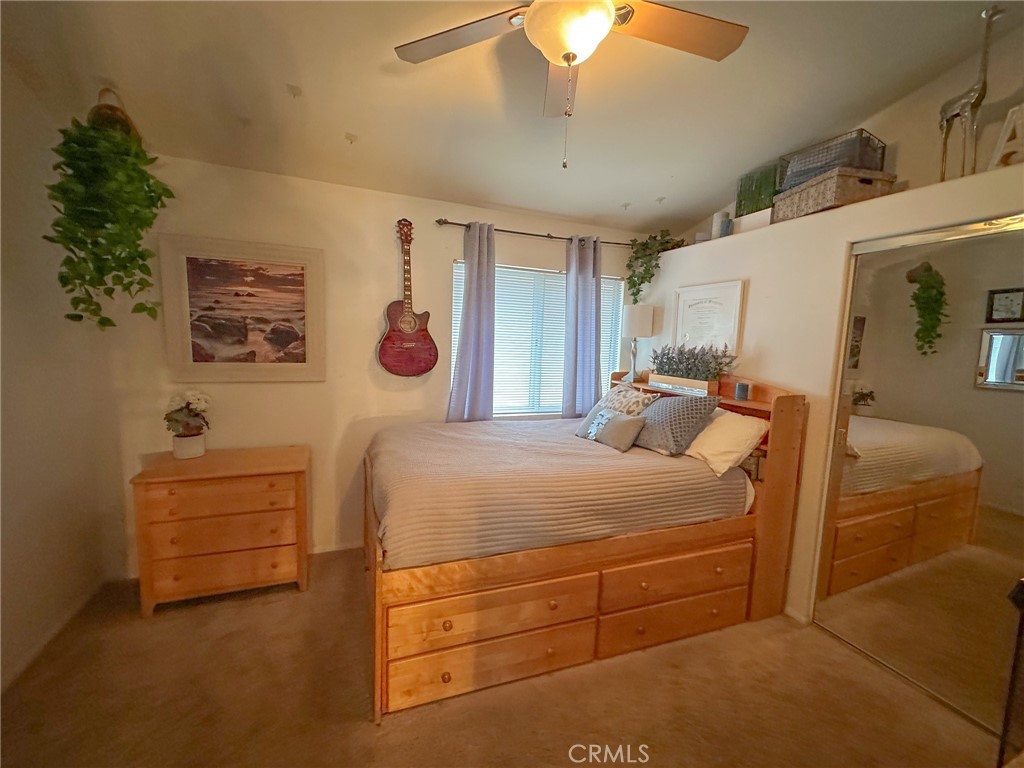 31785 Vía Del Viento Trabuco Canyon, CA 92679 - Photo 20 of 50 a bedroom with a bed and a chandelier