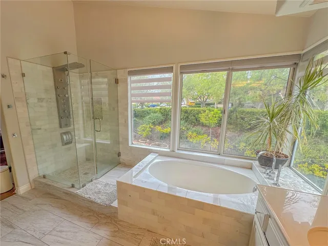 a spacious bathroom with a tub and window