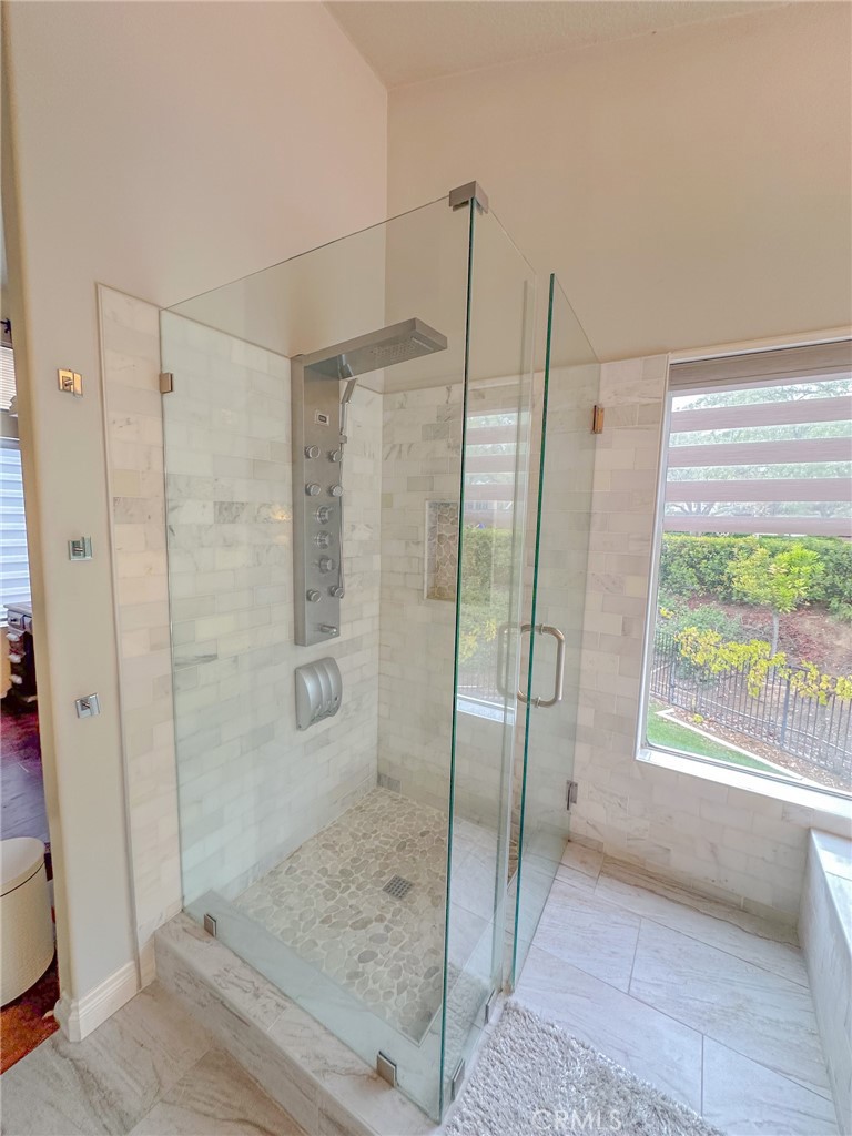 31785 Vía Del Viento Trabuco Canyon, CA 92679 - Photo 22 of 50 a bathroom with a glass shower door