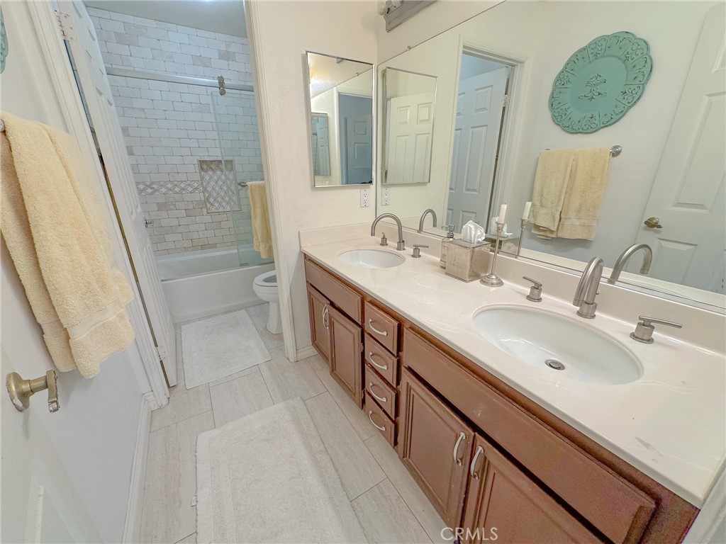 31785 Vía Del Viento Trabuco Canyon, CA 92679 - Photo 26 of 50 a bathroom with a double vanity sink a mirror and a shower