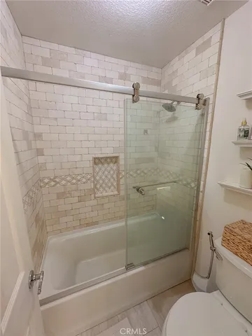 a bathroom with a toilet and shower
