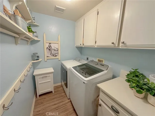 a utility room with sink dryer and washer