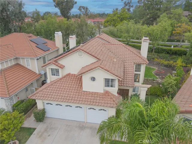 a aerial view of a house with a yard and potted plants