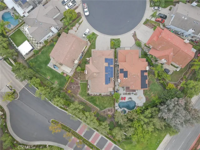 an aerial view of residential houses with outdoor space and street view