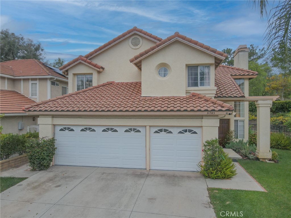 31785 Vía Del Viento Trabuco Canyon, CA 92679 - Photo 4 of 50 a view of a white house with a yard and plants