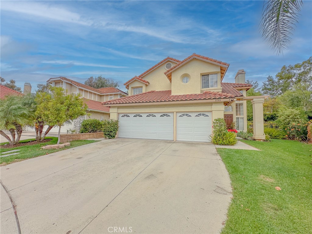 31785 Vía Del Viento Trabuco Canyon, CA 92679 - Photo 5 of 50 a view of a white house with a small yard and potted plants