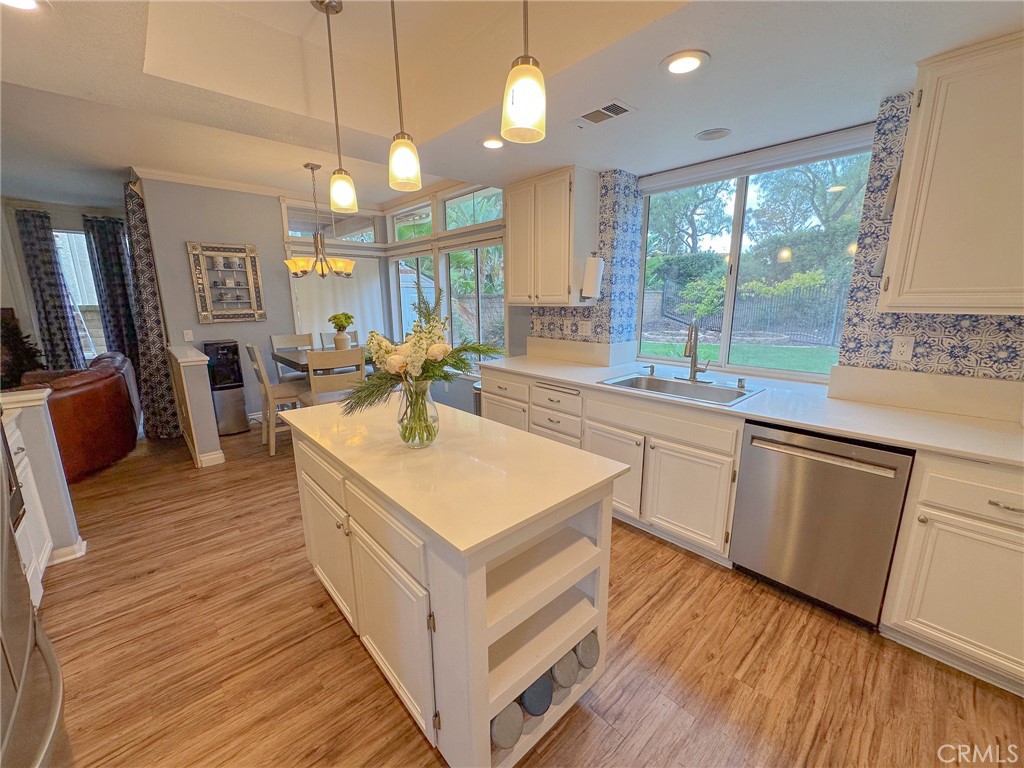 31785 Vía Del Viento Trabuco Canyon, CA 92679 - Photo 6 of 50 a kitchen with wooden floors and white cabinets