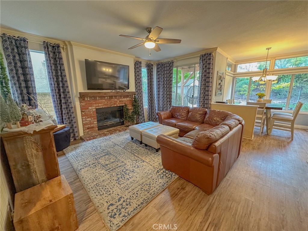 31785 Vía Del Viento Trabuco Canyon, CA 92679 - Photo 8 of 50 a living room with furniture flat screen tv and a fireplace