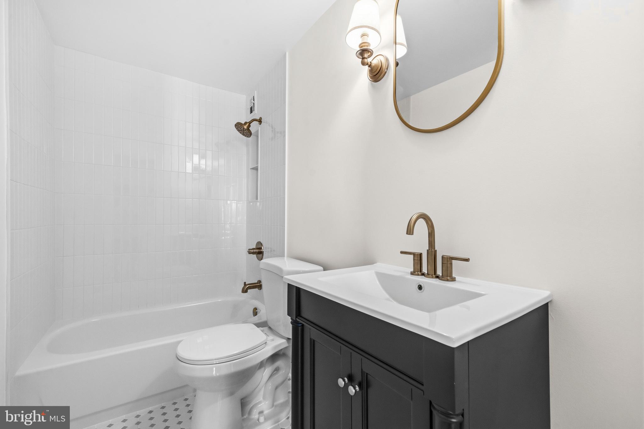 1851 Columbia Road Northwest, Unit 401 Washington, DC 20009 - Photo 14 of 27 a bathroom with a sink a toilet and shower
