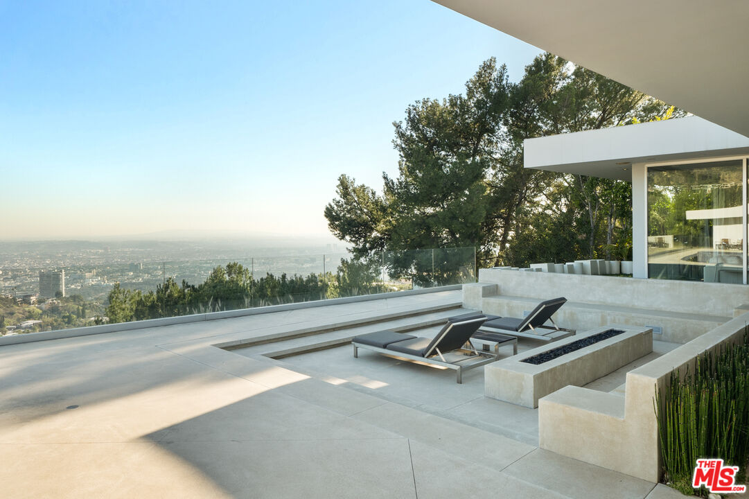 1610 Carla Ridge Beverly Hills, CA 90210 - Photo 2 of 14 a view of a swimming pool with a lounge chair