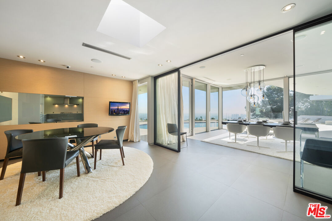 1610 Carla Ridge Beverly Hills, CA 90210 - Photo 5 of 14 a view of a dining room with furniture window and outside view