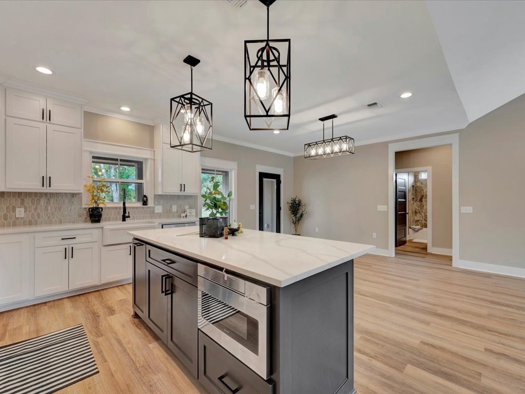 537 C C Road Diboll, TX 75941 - Photo 16 of 37 a large kitchen with granite countertop a white stove top oven and cabinets