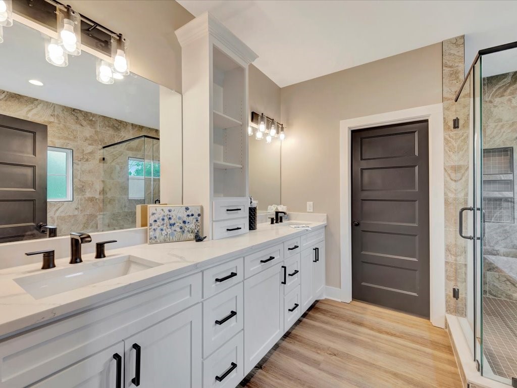 537 C C Road Diboll, TX 75941 - Photo 23 of 37 a bathroom with a double vanity sink and mirror