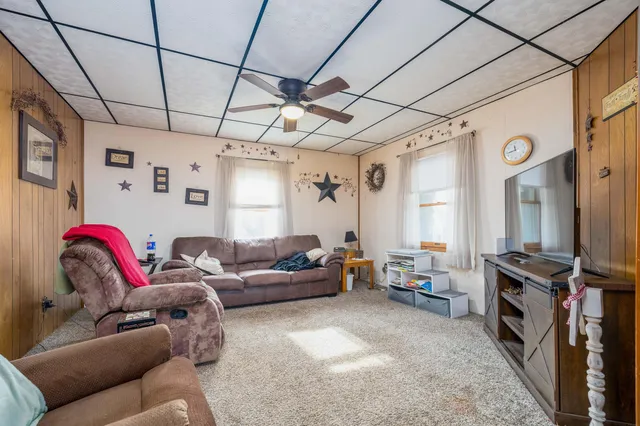 a living room with furniture a flat screen tv and a couch