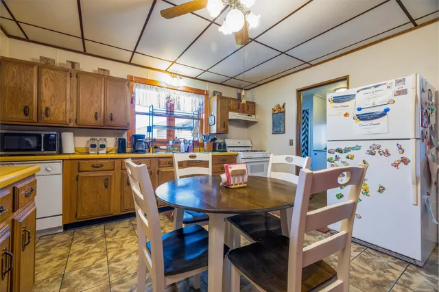 a dining room with a wooden table and chairs