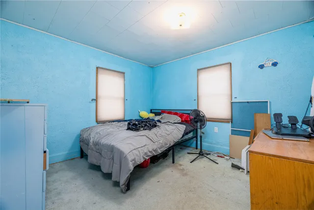 a bedroom with a bed and a table in it