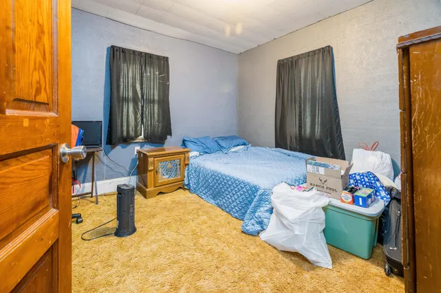 a bedroom with furniture and a window