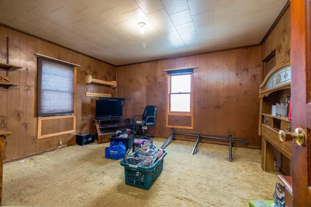 a living room with furniture gym equipment and a flat screen tv