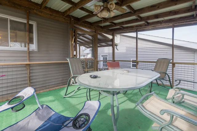 a backyard of a house with table and chairs