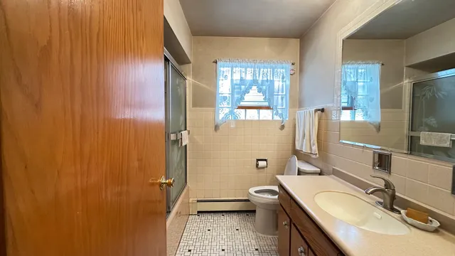 a bathroom with a sink double vanity granite tub and shower