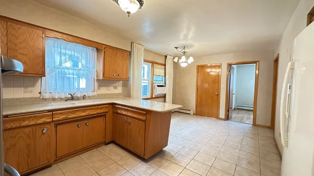 a view of a kitchen with a sink and cabinets