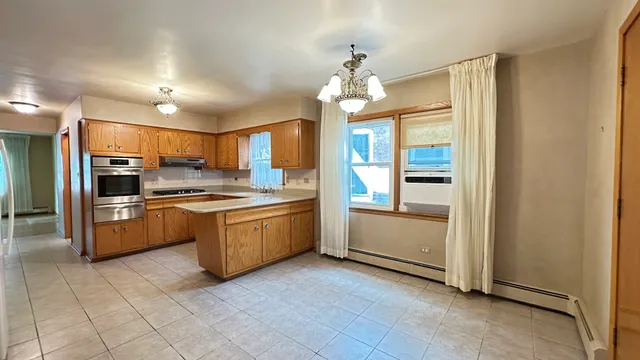 a kitchen with a refrigerator and a stove top oven