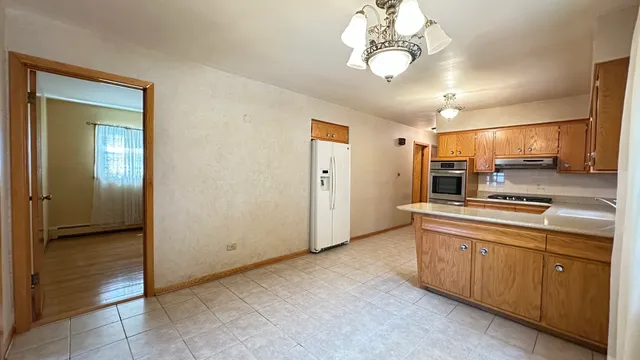 a view of a kitchen with electric appliances
