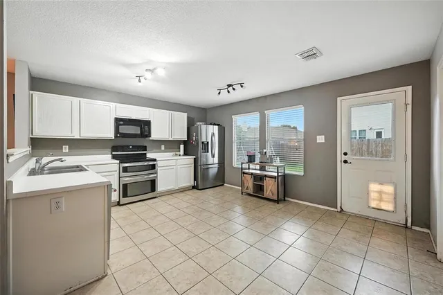 a view of a dining room with furniture and a chandelier