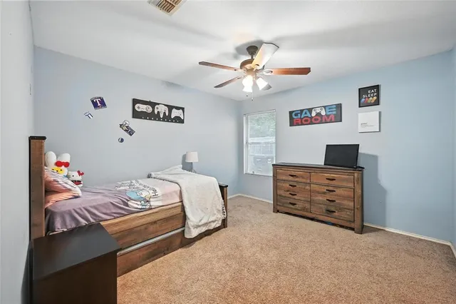 a bedroom with a bed chair and window