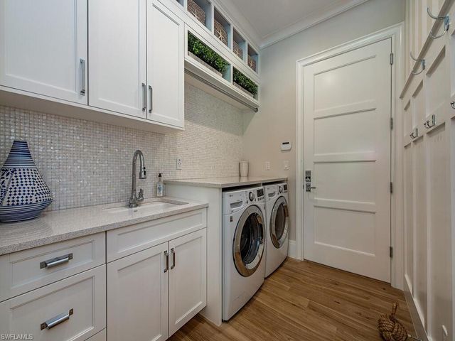 a utility room with sink dryer and washer
