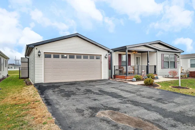 a view of a house with backyard porch and sitting area