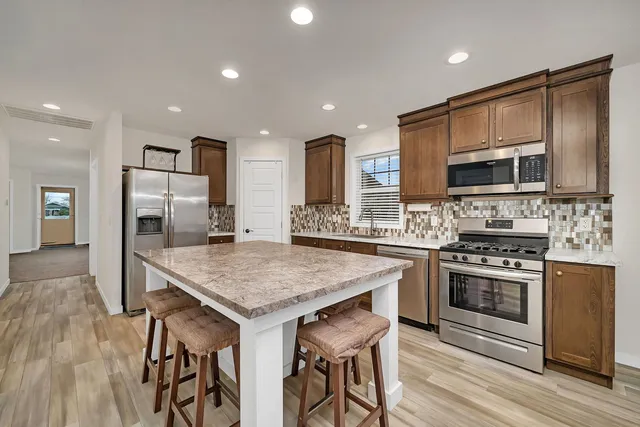 a kitchen with a stove a sink and a refrigerator