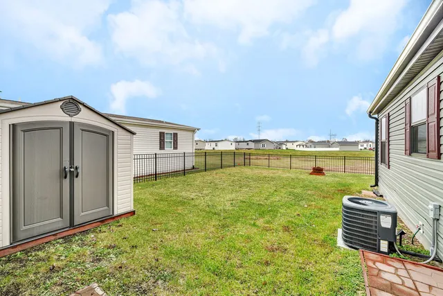 a view of a house with backyard and deck