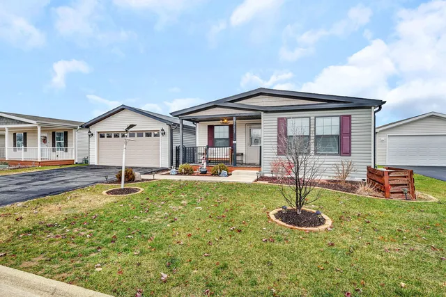 a front view of a house with swimming pool and porch