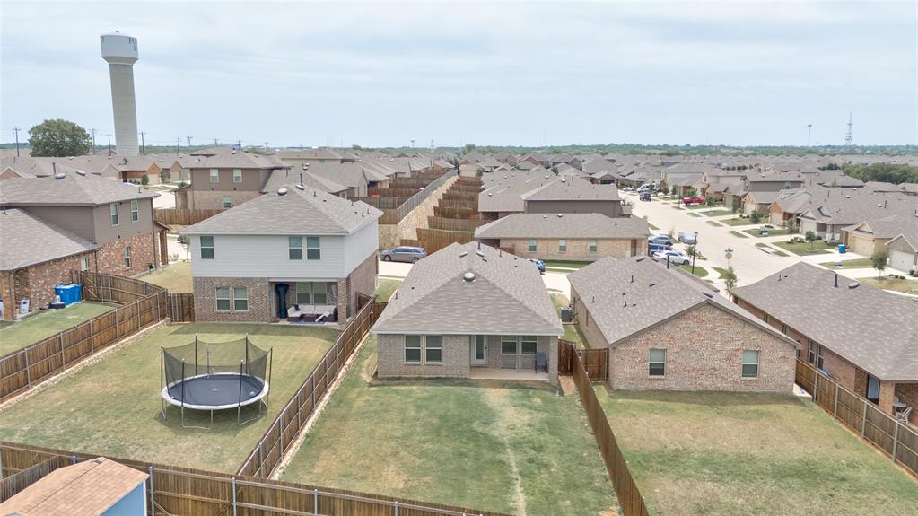 1016 Rio Bravo Drive Forney, TX 75126 - Photo 19 of 25 Fenced backyard with a covered patio, providing outdoor living space