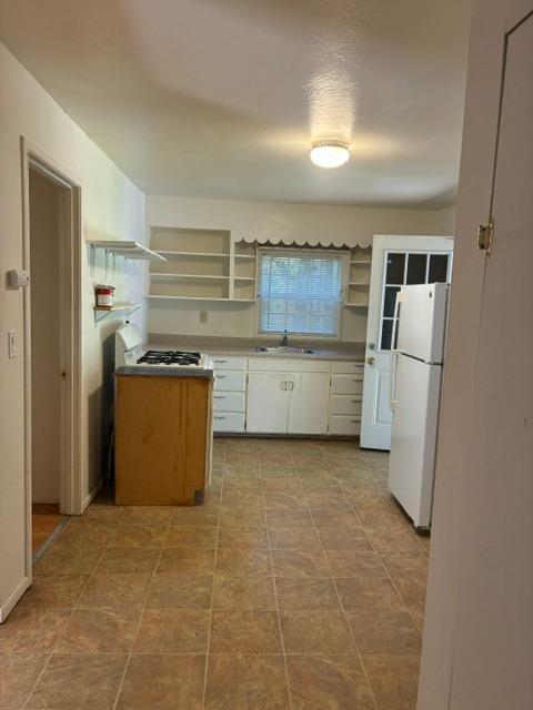 2823 Blair Road Pollock Pines, CA 95726 - Photo 3 of 15 a kitchen with a refrigerator stove and a sink