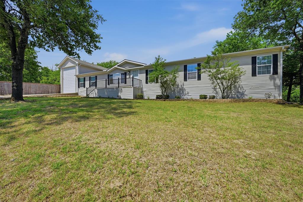 212 Sunset Road Pottsboro, TX 75076 - Photo 2 of 40 a front view of a house with garden