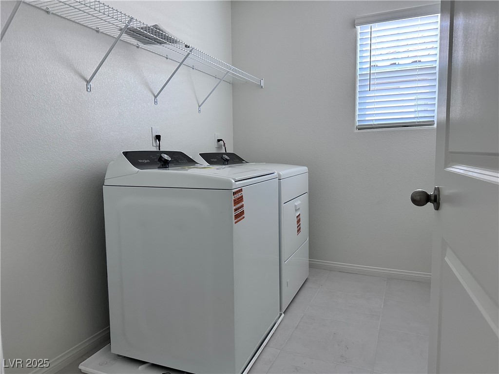 3634 Cameri Avenue Henderson, NV 89044 - Photo 13 of 22 Laundry area with washer and dryer and light tile patterned floors